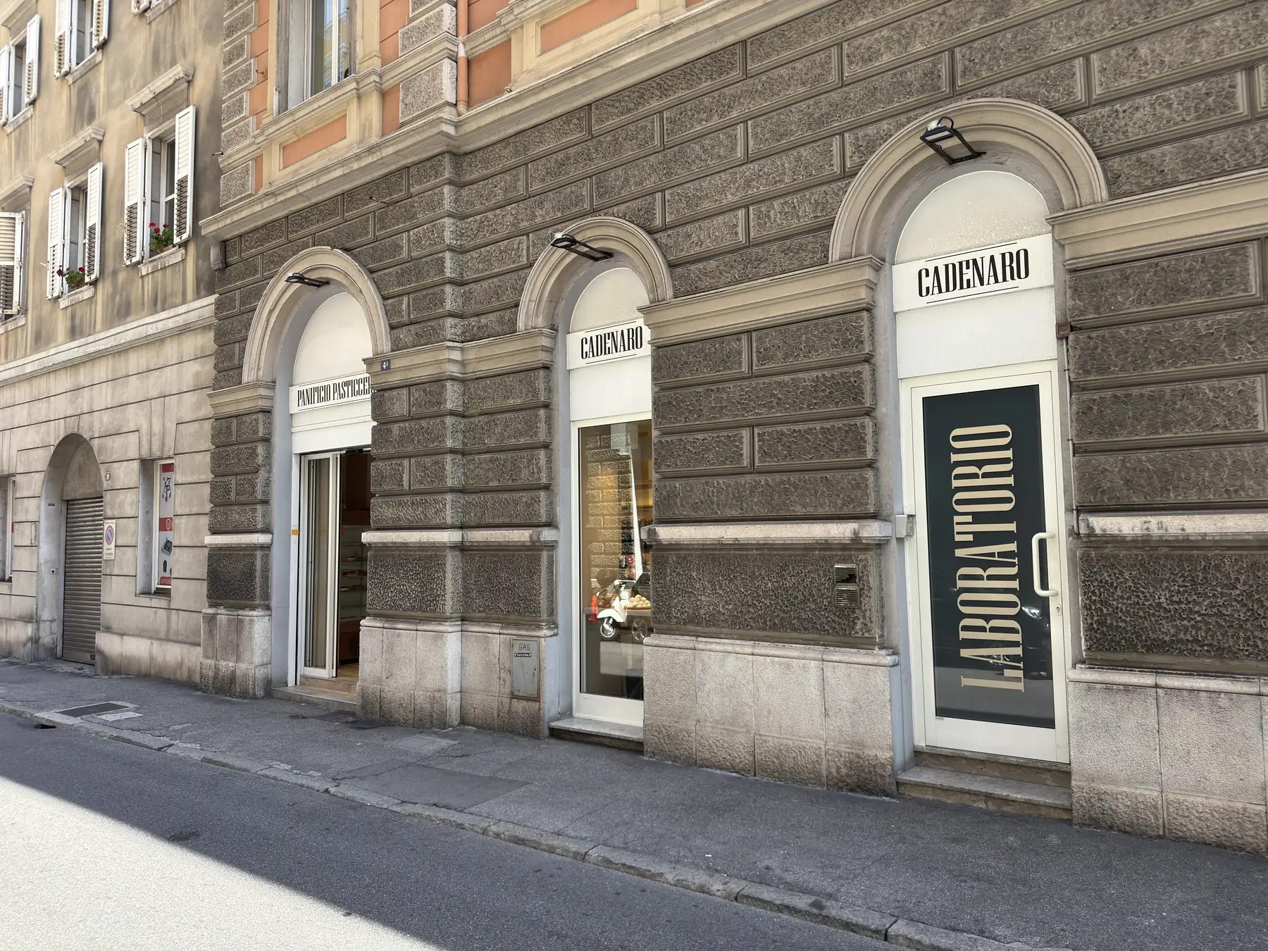 La facciata del panificio pasticceria Cadenaro in via Pierluigi da Palestrina a Trieste: le tre arcate con le vetrine e, a destra, la porta a vetri del laboratorio